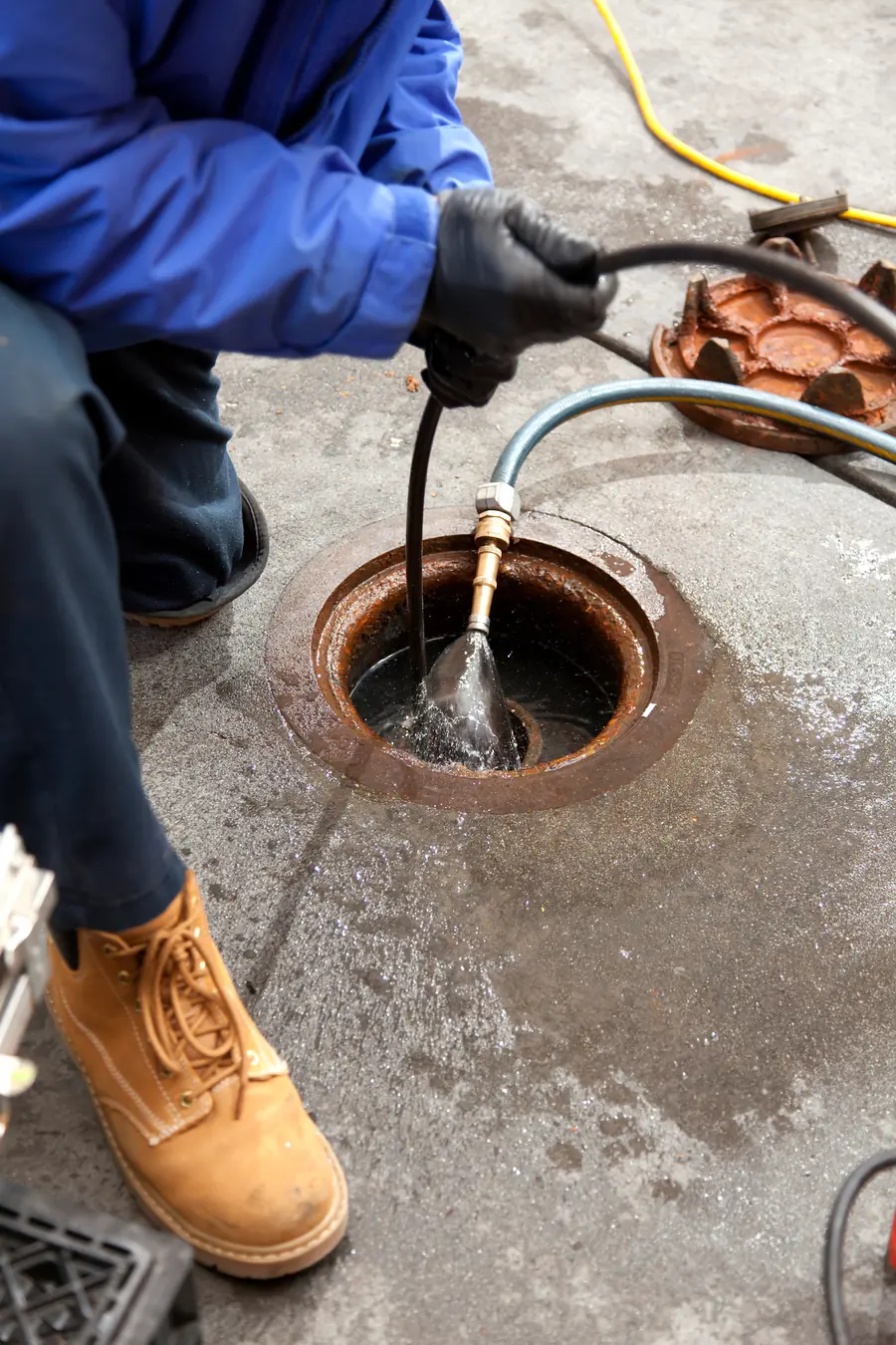 A drain being cleared with a high-pressure hose